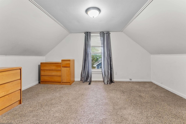 bonus room with lofted ceiling and carpet floors