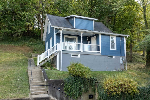 view of front of house featuring a front lawn and covered porch