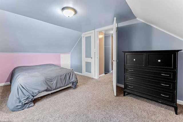 carpeted bedroom featuring vaulted ceiling