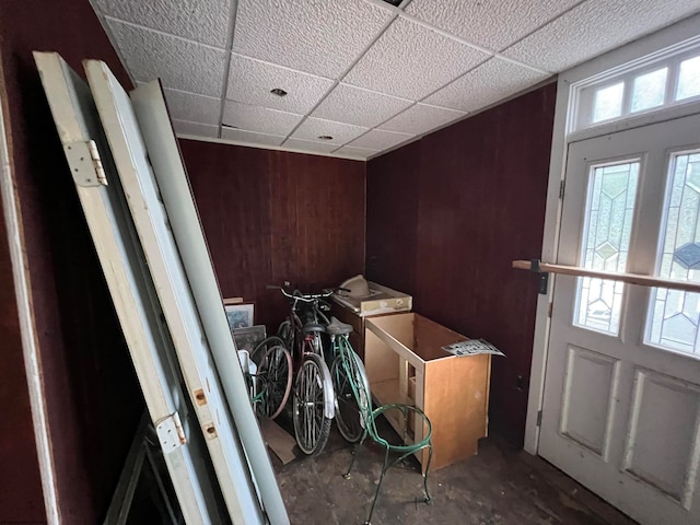 clothes washing area with wood walls