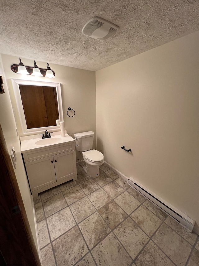 bathroom featuring vanity, a baseboard radiator, toilet, and a textured ceiling