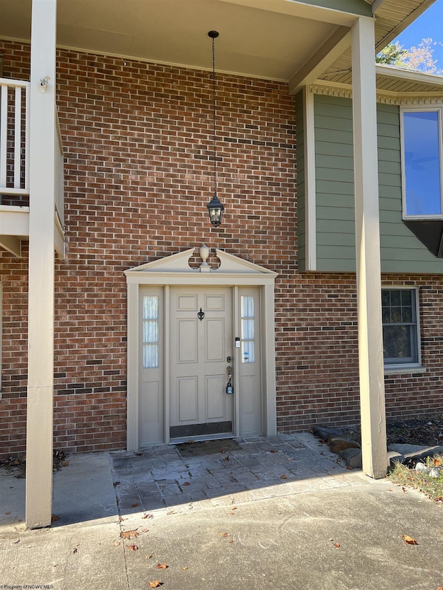 view of exterior entry with brick siding