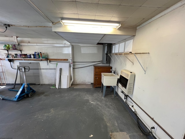 basement featuring heating unit and sink