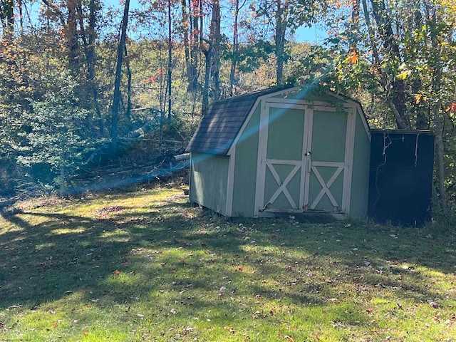 view of outdoor structure featuring a lawn