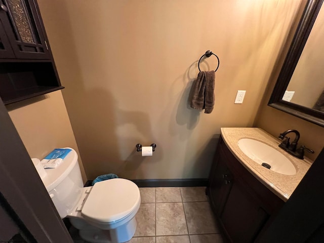 bathroom featuring toilet, tile patterned flooring, and vanity