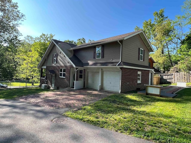 view of front facade with a front yard and a garage