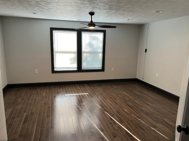 spare room featuring ceiling fan, a textured ceiling, and dark wood-type flooring