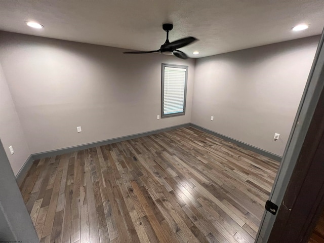 spare room featuring ceiling fan and hardwood / wood-style floors