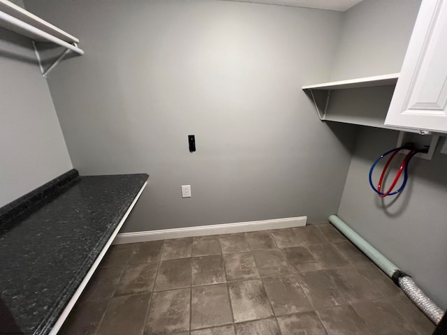 laundry room featuring hookup for a washing machine and cabinets