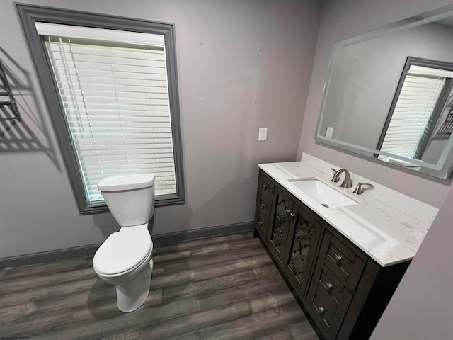 bathroom with vanity, hardwood / wood-style floors, and toilet