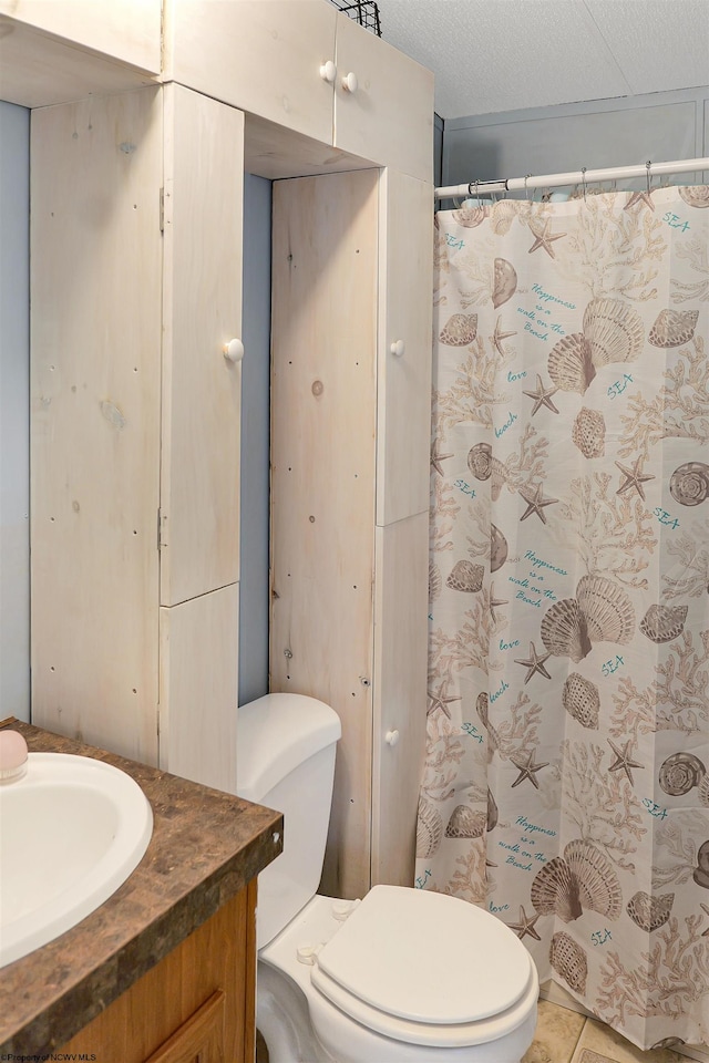 bathroom with tile patterned flooring, toilet, a textured ceiling, vanity, and a shower with curtain