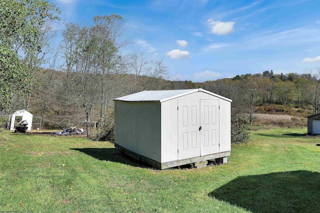 view of outdoor structure featuring a lawn