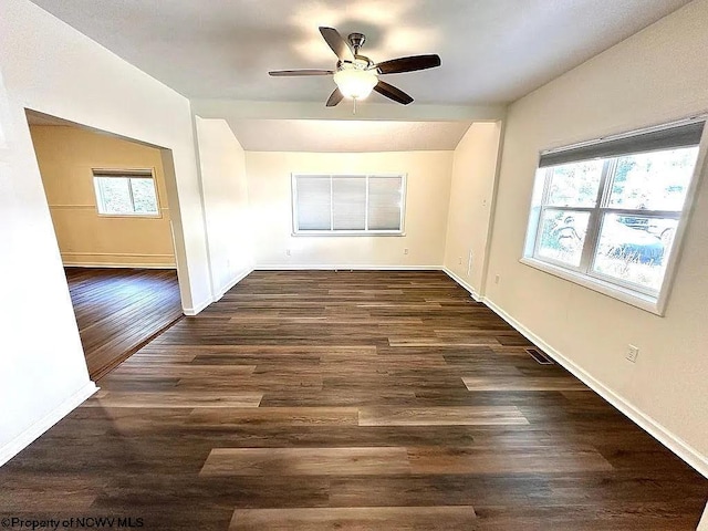 spare room featuring dark wood-type flooring and ceiling fan