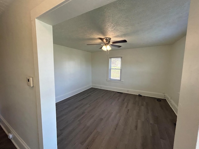 unfurnished room featuring ceiling fan, a textured ceiling, and dark hardwood / wood-style floors