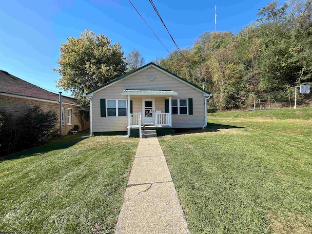 view of front of home with a front yard and covered porch