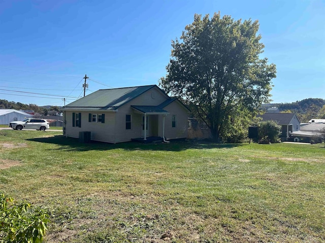 view of home's exterior featuring central AC and a lawn