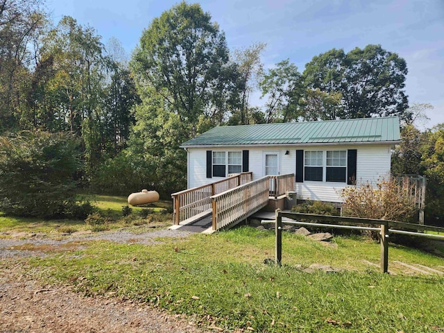 view of front facade with a front lawn and a deck