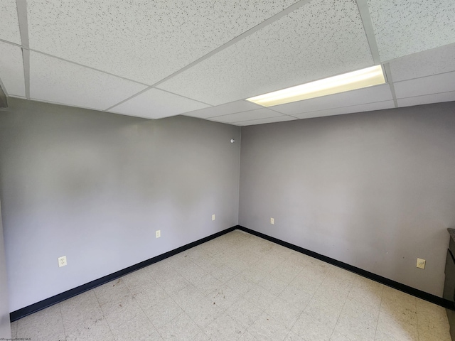 empty room featuring a drop ceiling