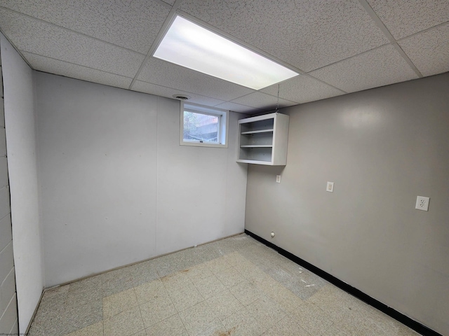 basement featuring a paneled ceiling