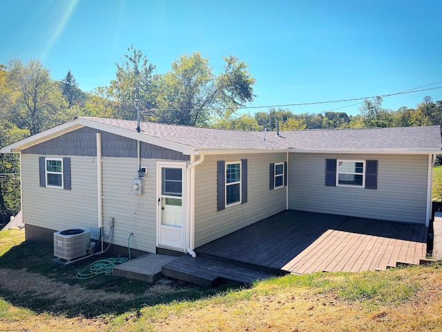 back of house featuring cooling unit and a wooden deck