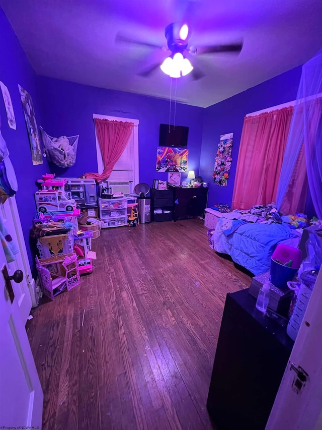 bedroom with ceiling fan and hardwood / wood-style flooring