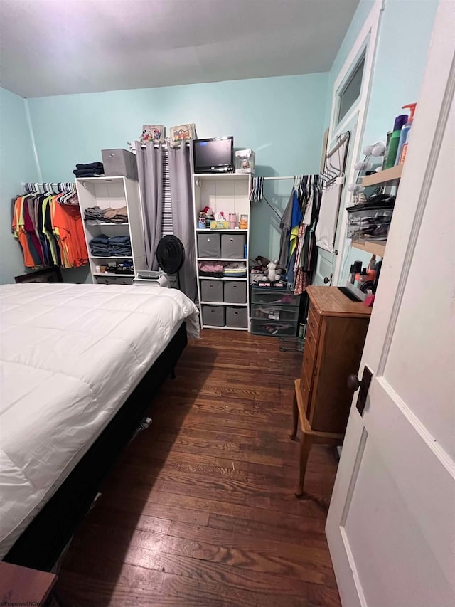 bedroom with dark hardwood / wood-style floors