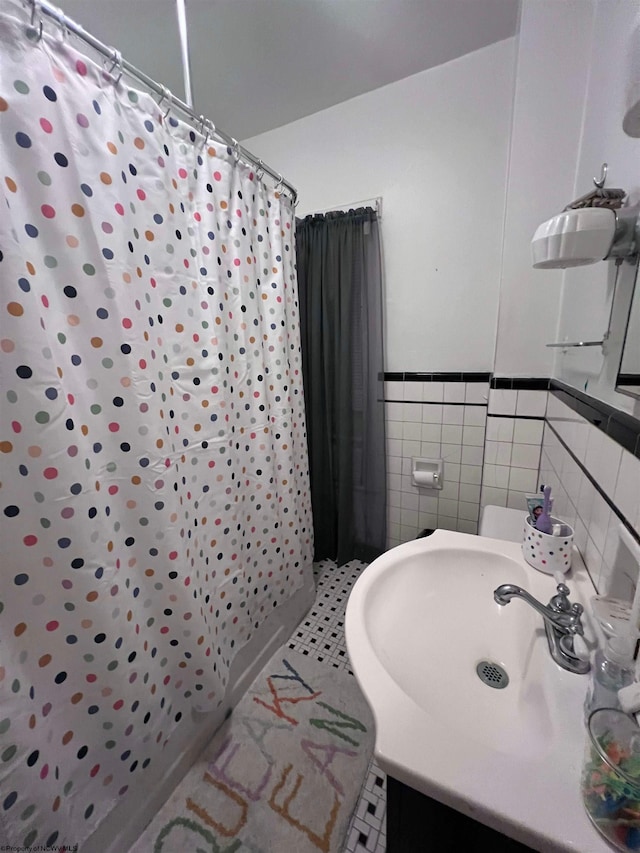 bathroom with vanity, tile walls, tile patterned floors, and a shower with shower curtain