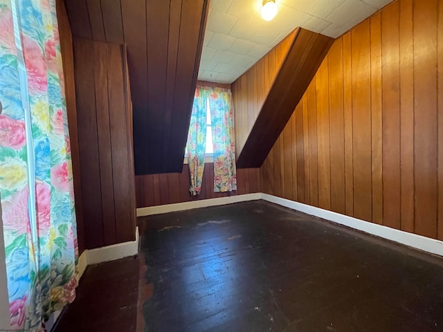 bonus room featuring wooden walls