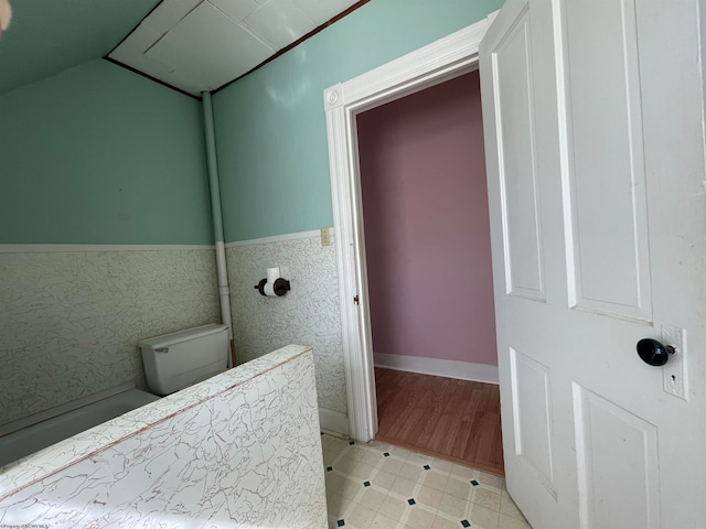 bathroom featuring toilet and vaulted ceiling