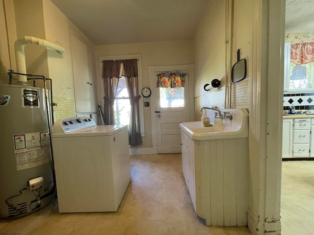 laundry room with gas water heater and sink