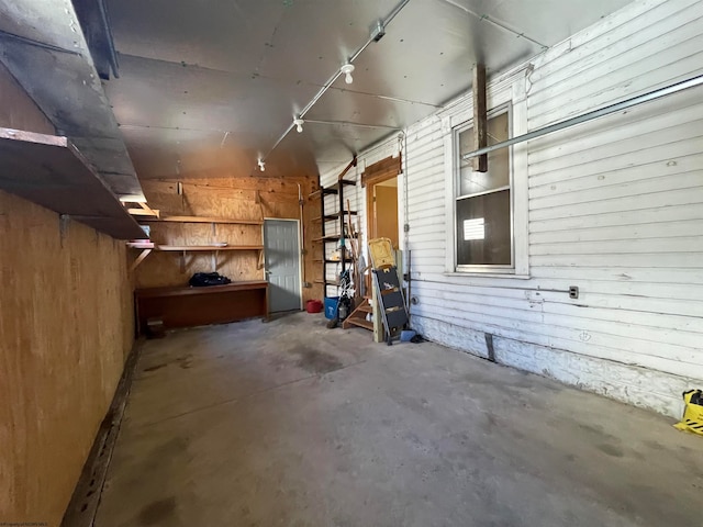 basement featuring wood walls