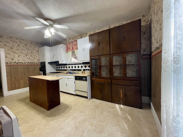 kitchen featuring ceiling fan, white cabinets, dishwasher, and a center island