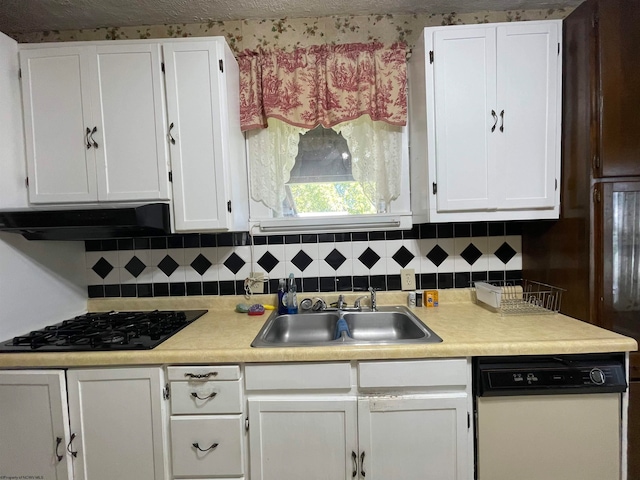 kitchen with dishwasher, sink, tasteful backsplash, and white cabinetry