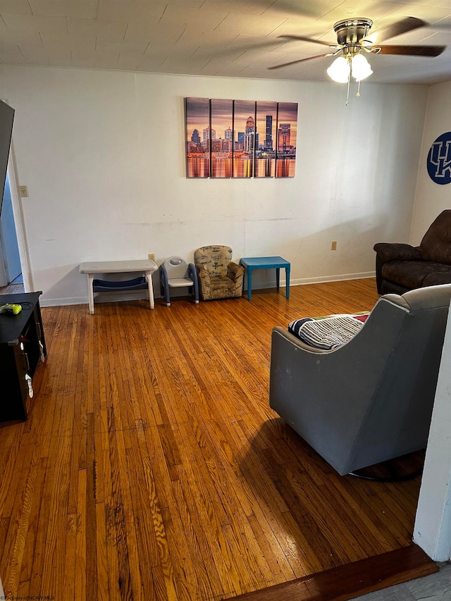 living room featuring ceiling fan and wood-type flooring