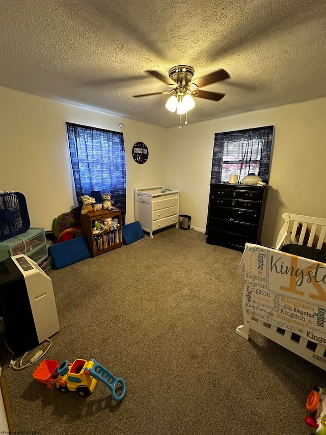 carpeted bedroom with ceiling fan and a textured ceiling