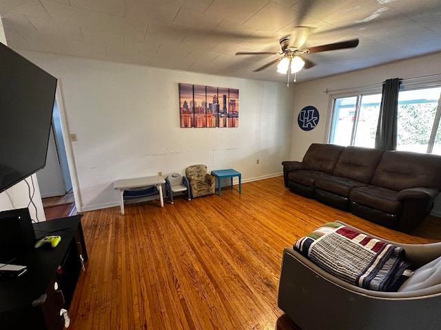 living room with hardwood / wood-style floors and ceiling fan