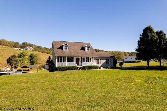 cape cod house with covered porch and a front yard