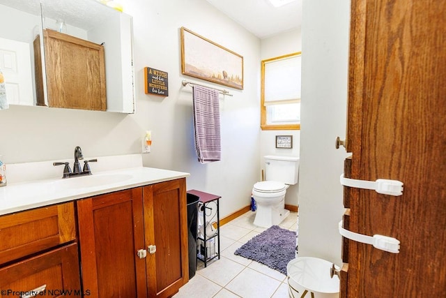 bathroom featuring tile patterned floors, vanity, and toilet