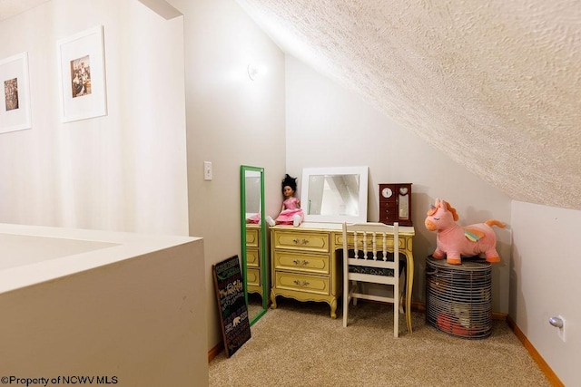 interior space with a textured ceiling and vaulted ceiling