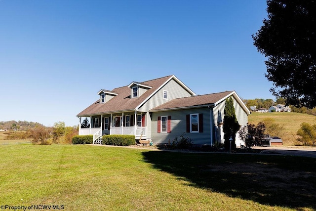 cape cod home with covered porch and a front lawn