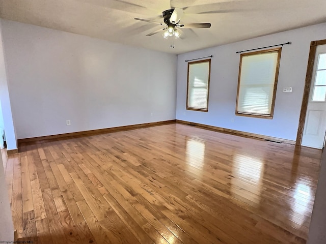 unfurnished room with hardwood / wood-style flooring and ceiling fan