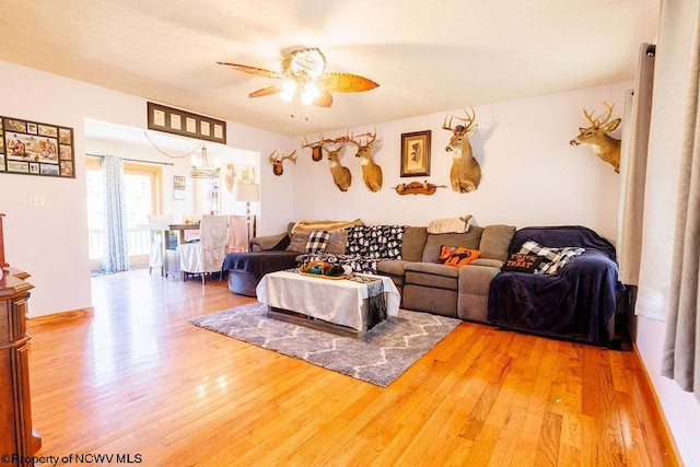 living room featuring ceiling fan and wood-type flooring