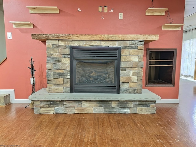 details featuring wood-type flooring and a stone fireplace