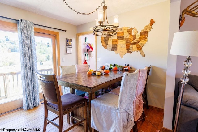 dining space featuring a chandelier and wood-type flooring