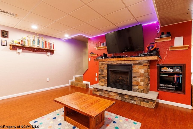 living room with a fireplace and hardwood / wood-style flooring