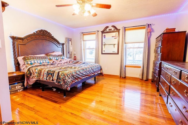 bedroom with ceiling fan and light wood-type flooring