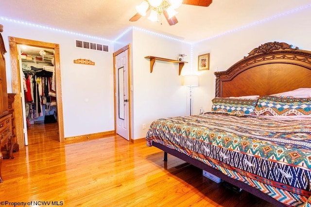 bedroom featuring ceiling fan, a closet, and wood-type flooring