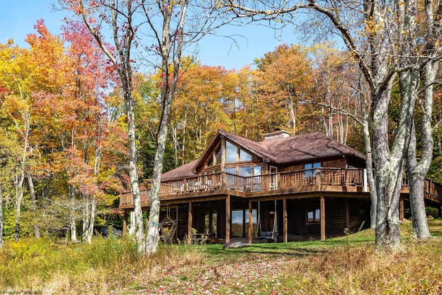 back of property with a wooden deck