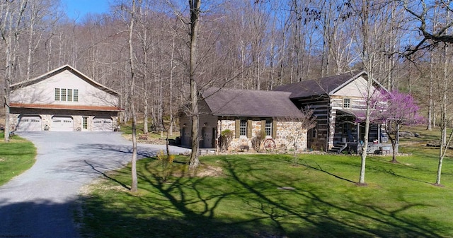 view of front of house featuring a garage and a front lawn