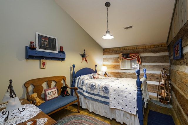 bedroom with wood walls, wood-type flooring, and vaulted ceiling